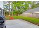 A fully fenced backyard with a grass lawn, concrete patio, and cozy firepit seating area at 144 Jupiter Ln, Summerville, SC 29483