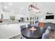 Open concept dining area with stylish light fixture, modern table and chairs with a view to the kitchen and living room at 144 Jupiter Ln, Summerville, SC 29483
