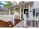Inviting front porch with white columns, hanging plants, and a decorative wreath on the front door at 144 Jupiter Ln, Summerville, SC 29483
