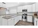 Updated kitchen features white cabinets, granite countertops, stainless steel appliances and stylish backsplash at 144 Jupiter Ln, Summerville, SC 29483