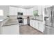 Bright kitchen features white cabinets, stainless steel appliances, granite countertops, and a stylish backsplash at 144 Jupiter Ln, Summerville, SC 29483