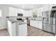 Well-lit kitchen features white cabinets, stainless steel appliances, granite countertops, and stylish backsplash at 144 Jupiter Ln, Summerville, SC 29483