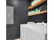 Efficient laundry room with washer, dryer, shelving, and dark walls for a modern look at 144 Jupiter Ln, Summerville, SC 29483
