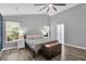 Comfortable main bedroom with two windows, a ceiling fan, and wood-look floors at 144 Jupiter Ln, Summerville, SC 29483