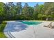 A community pool with a paved sundeck and chaise lounge chairs at 144 Jupiter Ln, Summerville, SC 29483