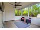 Relaxing screened porch with comfortable seating and an overhead ceiling fan at 144 Jupiter Ln, Summerville, SC 29483
