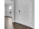 Bright entryway featuring a white front door, gray walls, and wood flooring flowing into an open space at 145 Threaded Fern St, Summerville, SC 29485