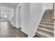 Welcoming entryway featuring hardwood floors, staircase, and an open view to the kitchen and living area at 145 Threaded Fern St, Summerville, SC 29485