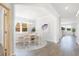 Bright dining area with hardwood floors, a round table with seating for four, and large windows with natural light at 147 Threaded Fern St, Summerville, SC 29485