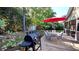 A backyard patio with a grill, furniture, and a red umbrella for an enjoyable outdoor experience at 148 Jupiter Ln, Summerville, SC 29483