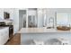 Modern kitchen with stainless steel appliances, white cabinets, and a spacious quartz countertop at 151 Threaded Fern St, Summerville, SC 29485