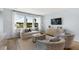 Bright living room with large windows offering scenic views, comfortable seating, and stylish decor at 151 Threaded Fern St, Summerville, SC 29485