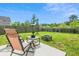 A backyard with patio seating, a fire pit, trees, and a wooden fence, offering a relaxing outdoor space at 161 Brittondale Rd, Summerville, SC 29485