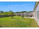 Spacious backyard featuring a large lawn, a seating area, a fire pit, and a wood fence at 161 Brittondale Rd, Summerville, SC 29485