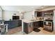 Modern kitchen with stainless steel appliances and dark cabinetry, open to living area at 161 Brittondale Rd, Summerville, SC 29485