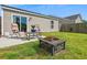 Outdoor patio with a table, seating, and a fire pit, perfect for outdoor relaxing and enjoying the backyard at 161 Brittondale Rd, Summerville, SC 29485