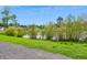 Picturesque view of a tranquil pond surrounded by lush greenery and a wooden fence, accessible via a gravel path at 161 Brittondale Rd, Summerville, SC 29485