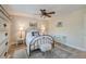 Cozy bedroom with iron bed frame, ceiling fan, decorative rug, and bright natural light at 165 River Breeze Dr, Charleston, SC 29407