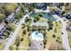 Aerial view of a community with a pond, tennis court, and pool surrounded by lush landscaping at 165 River Breeze Dr, Charleston, SC 29407