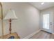 Inviting entryway with wood-look flooring, decorative lamp, door with blinds, and a glimpse of outdoor light at 165 River Breeze Dr, Charleston, SC 29407