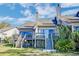 Back exterior of the townhouse with multiple decks and staircases, leading to a green backyard at 165 River Breeze Dr, Charleston, SC 29407