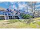 Back exterior of the townhouses showcasing decks and stairs on a green lawn at 165 River Breeze Dr, Charleston, SC 29407