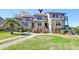 Attractive townhouse-style condos with well-manicured lawns and landscaped gardens with blooming flowers at 165 River Breeze Dr, Charleston, SC 29407