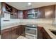 Well-equipped kitchen with stainless steel appliances, granite countertops, and rich dark wood cabinets at 165 River Breeze Dr, Charleston, SC 29407