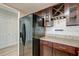A kitchen with dark wood cabinets, granite countertops, and stainless steel appliances provides modern convenience and style at 165 River Breeze Dr, Charleston, SC 29407