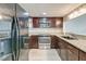 Modern kitchen featuring stainless steel appliances, granite countertops, dark wood cabinets, and new floors at 165 River Breeze Dr, Charleston, SC 29407
