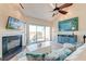 Inviting living room with fireplace, ceiling fan, and sliding glass doors leading to an outdoor deck at 165 River Breeze Dr, Charleston, SC 29407