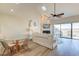 Cozy living room with vaulted ceilings, fireplace, and access to outdoor deck, offering a relaxing retreat at 165 River Breeze Dr, Charleston, SC 29407