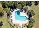 Aerial view of a sparkling pool surrounded by lounge chairs and lush landscaping, perfect for summer relaxation at 165 River Breeze Dr, Charleston, SC 29407