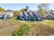 Aerial view of a townhouse complex featuring private decks surrounded by trees and marsh views at 165 River Breeze Dr, Charleston, SC 29407