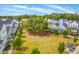 A large grassy area with mature trees bordered by colorful homes at 1656 Indy Dr, North Charleston, SC 29405