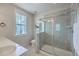 Bright bathroom featuring double vanity sinks, a window, a toilet and a glass enclosed shower at 1656 Indy Dr, North Charleston, SC 29405