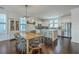 Open dining area with wooden table, modern chairs, and a view of the modern kitchen at 1656 Indy Dr, North Charleston, SC 29405
