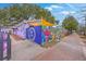 A unique purple building exterior with a graffiti fence, capturing an artistic outdoor vibe at 1656 Indy Dr, North Charleston, SC 29405