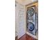 Compact laundry closet featuring a stacked washer and dryer at 1656 Indy Dr, North Charleston, SC 29405
