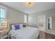Cozy main bedroom featuring hardwood floors, a plush bed with blue pillows, and an ensuite bathroom at 1656 Indy Dr, North Charleston, SC 29405