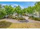 A serene park featuring a stone bench, gravel paths, and lush greenery at 1656 Indy Dr, North Charleston, SC 29405