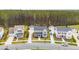 This aerial view captures the home's setting within a well-planned community, showcasing lush landscaping and multiple garages at 184 Clearblue Loop, Summerville, SC 29486