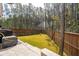 Fenced backyard with green lawn, tall trees in the background, and a paver patio at 184 Clearblue Loop, Summerville, SC 29486
