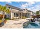 Stunning backyard boasts in-ground pool, screened-in patio, and spacious stone patio area at 184 Clearblue Loop, Summerville, SC 29486