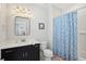Well-lit bathroom featuring a black vanity cabinet with white countertop and shower-tub at 184 Clearblue Loop, Summerville, SC 29486