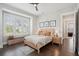 Cozy bedroom with hardwood floors, a bed, and a large window with blinds at 184 Clearblue Loop, Summerville, SC 29486