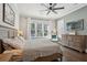 A serene bedroom with a king-size bed, natural light, and coastal-inspired decor with wood accent wall at 184 Clearblue Loop, Summerville, SC 29486