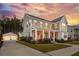A beautiful home at sunset, featuring a spacious porch and abundant natural light streaming through the windows at 184 Clearblue Loop, Summerville, SC 29486