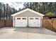 Two-car garage featuring white doors, gray siding, and concrete driveway, providing ample parking and storage space at 184 Clearblue Loop, Summerville, SC 29486