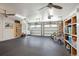 Well-lit garage featuring storage shelving, bicycles, white shiplap walls, and dual garage doors at 184 Clearblue Loop, Summerville, SC 29486